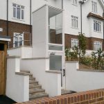 white hydraulic lift in front of residential homes