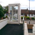 white hydraulic lift opposite residential homes