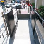 Mira low-rise platform lift outside a building on a busy road next to a Costa Coffee