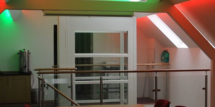 Kent Scouts meeting room with red and green lights showing the internal lift in the background