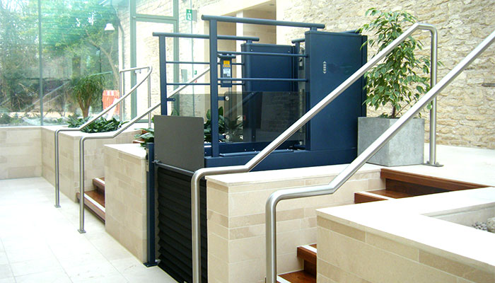 A low rise platform lift located alongside an external staircase